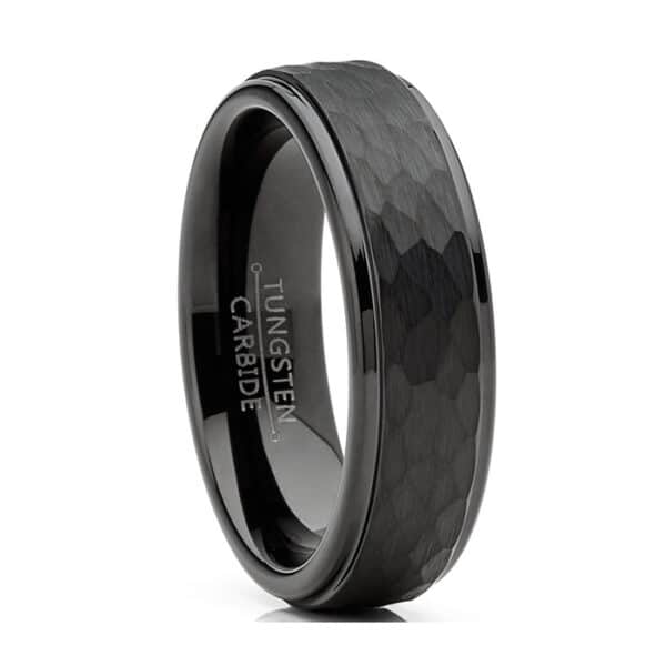 A black minimalist tungsten men's wedding band in 6mm featuring a hammered-brushed center and smooth edges and sleeve.