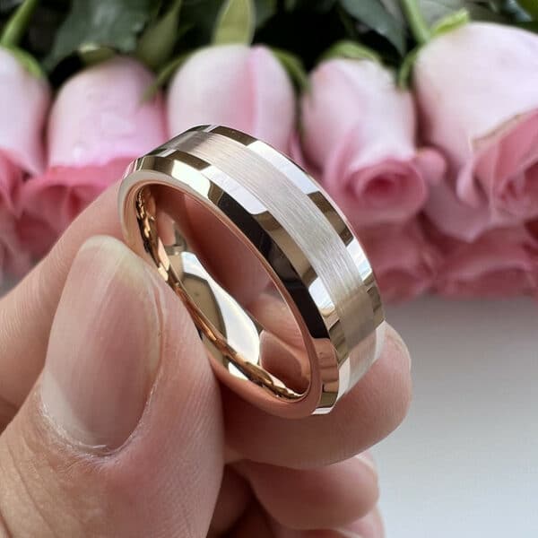 Fingers holding a 6mm 18k gold-plated men's wedding ring that features beveled edges and a thin brushed finish.