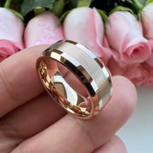 A classic but modern 18K gold-plated men's wedding ring with polished beveled edges, a brushed center, and comfort-fit sleeve resting in a hand.