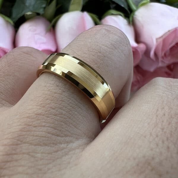 A 6mm 18K gold-plated men's wedding ring with a brushed finish at its center and polished beveled edges on a ring finger.