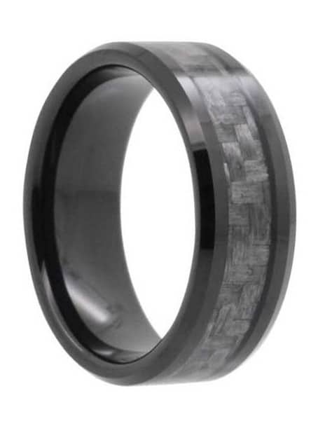 A modern men's wedding band that features a carbon fiber inlay, a polished finish, and beveled edges and sleeve.