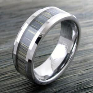 A grey tungsten carbide men’s wedding band with carbon fiber and silver sleeves.