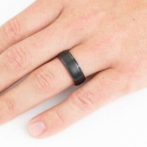 The Jace's black shines on a ring finger with its brushed center and polished edges.