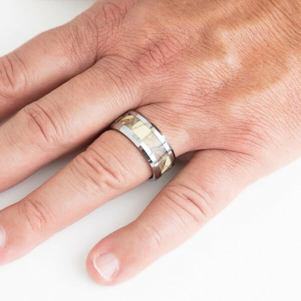 A ring finger wears the Jake and showcases its simplicity and style through its camo inlay, beveled edges, and polished finish.
