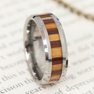A tungsten men’s wedding band with bamboo wood inlay and polished finish.