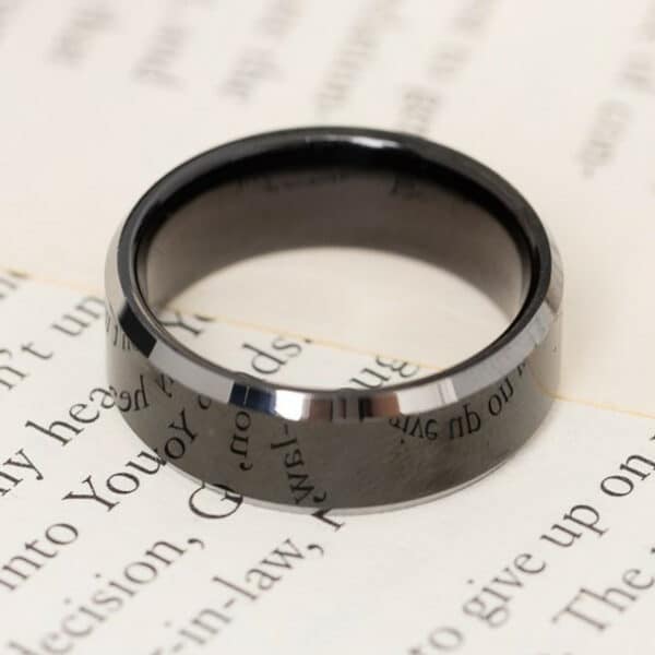 An 8mm black tungsten wedding ring for men featuring silver edges, a polished finish and sleeve that offers comfort-fit.